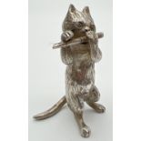 An Edwardian silver novelty container modelled as a cat playing the flute, with hinged head.