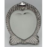 A large Victorian silver fronted, heart shaped mirror of stylised sinuous design. Hallmarked for