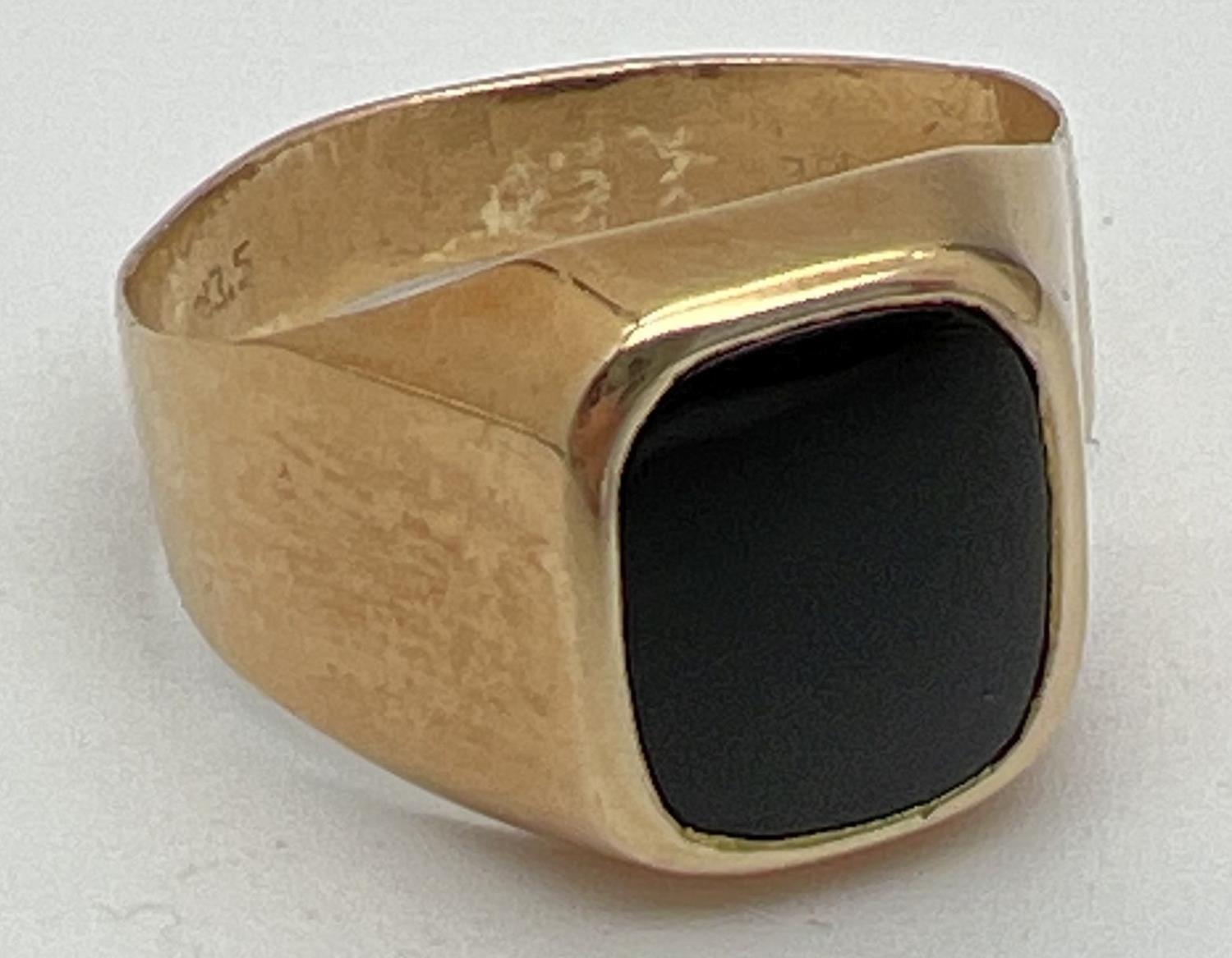 A men's 20ct gold and black onyx signet ring, band slightly misshapen. Stamped 83.5 inside band.