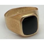 A men's 20ct gold and black onyx signet ring, band slightly misshapen. Stamped 83.5 inside band.