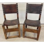 2 dark oak Arts & Crafts style wooden block chairs with leather backs and seats. Large brass stud