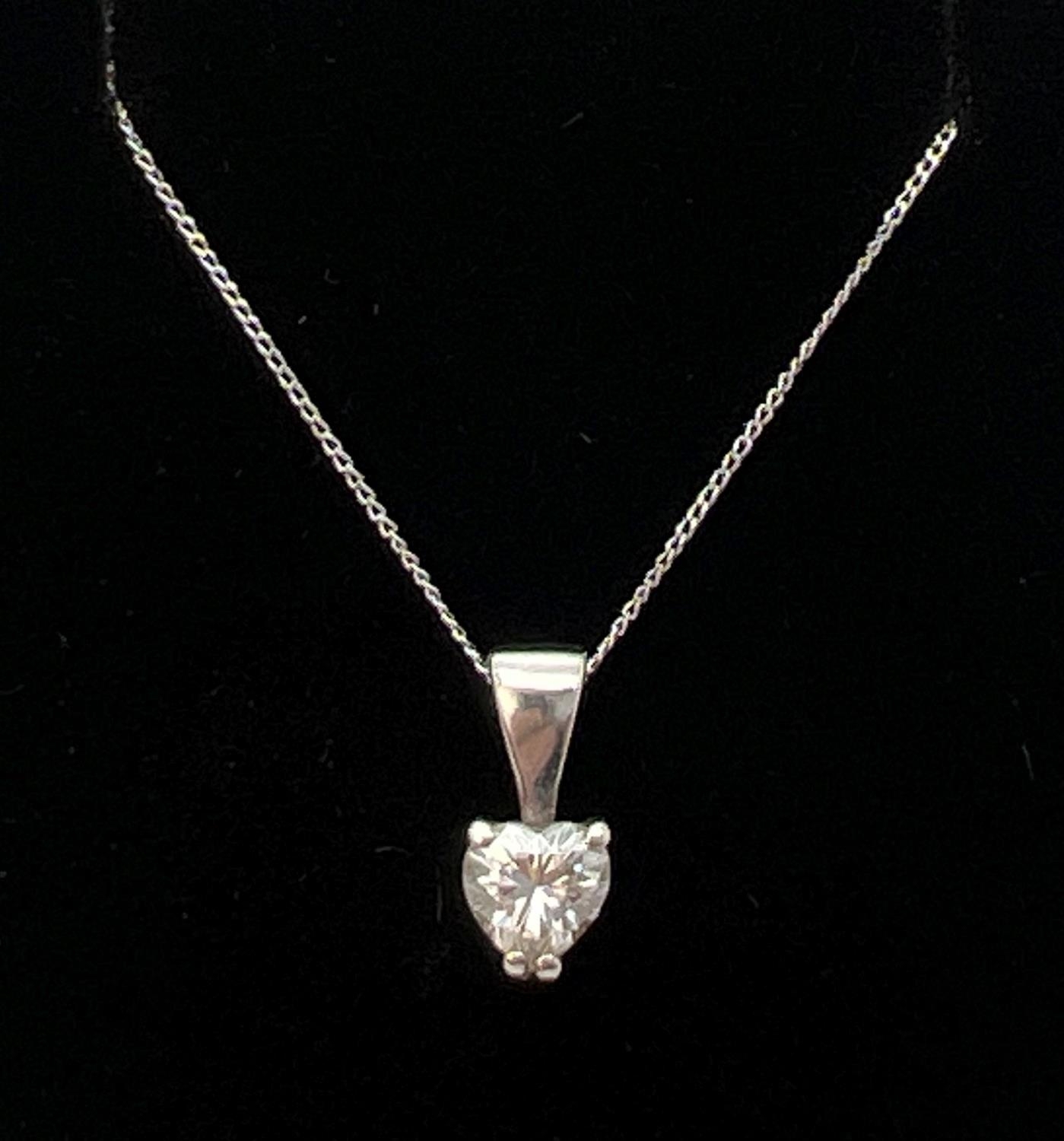 A 9ct white gold heart shaped pendant set with approx. 20ct moissanite stone. On an 18" fine white