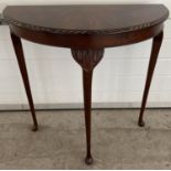 A vintage mahogany half circular, 3 legged hall table by the Northampton Cabinet Co Ltd. With carved
