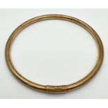 A vintage 9ct gold bangle with engraved floral pattern. Bangle has been repaired and strengthened