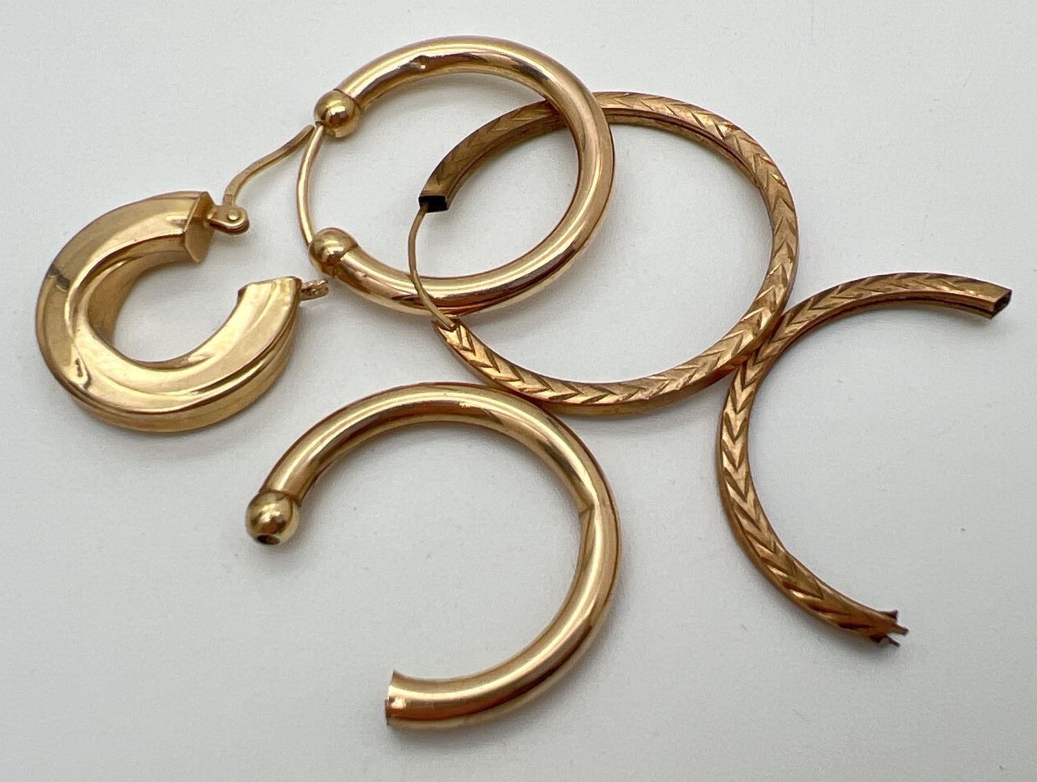 A small quantity of scrap gold hoop style earring. All marked or test as 9ct gold. Total weight