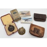 A small collection of mixed vintage items. To include a brass RAF cap badge, a boxed Royal Life
