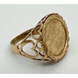 A 9ct gold St. George medallion signet ring with pierced heart decoration to both shoulders and