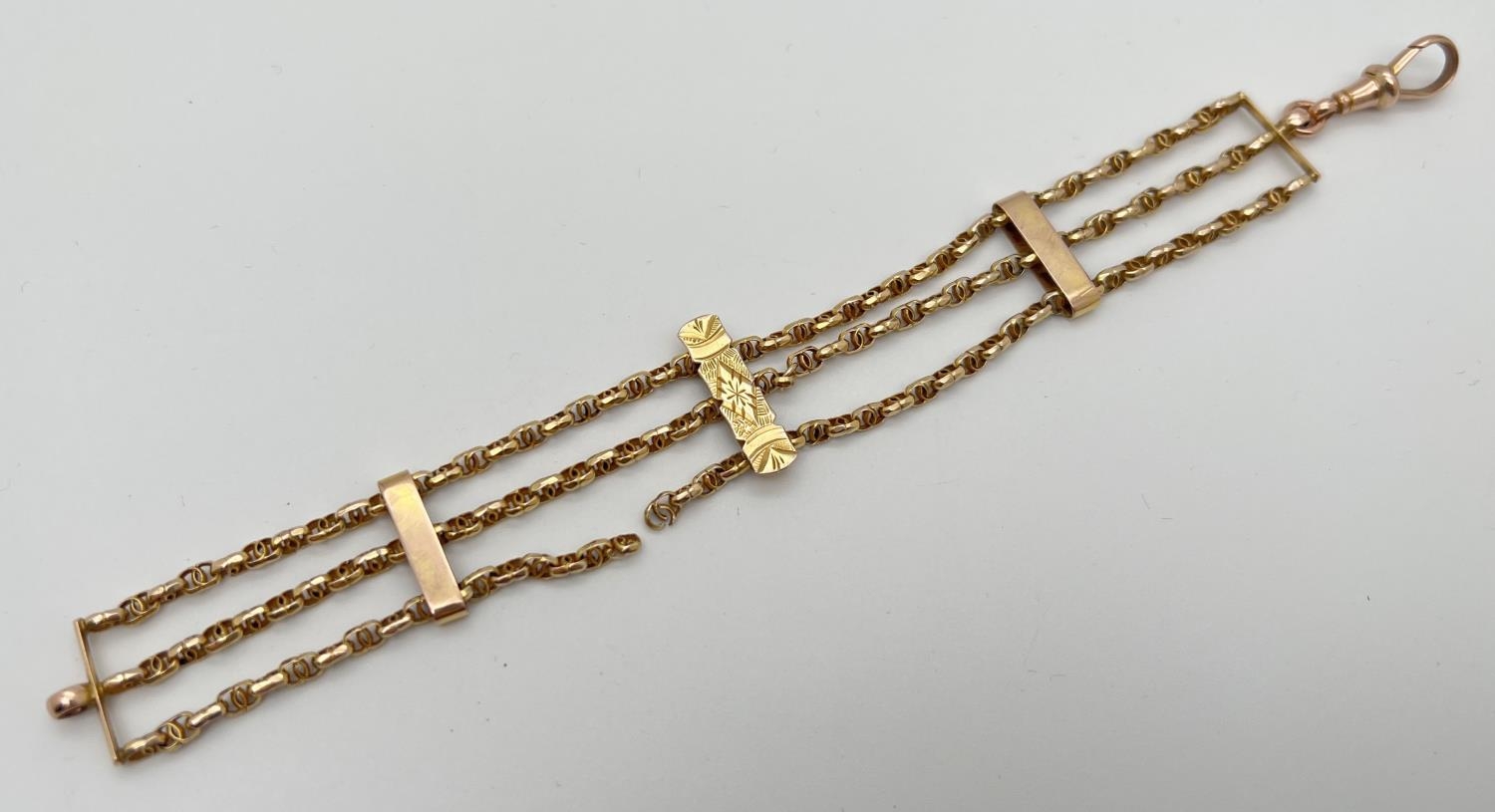 A vintage yellow gold 3 bar style bracelet with decorative chain links and rose gold lobster claw