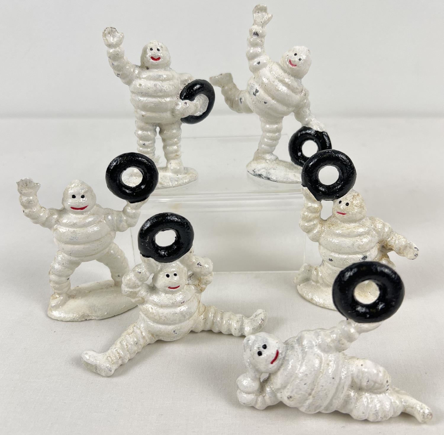 6 small painted cast metal Michelin Man figures, each holding a tyre. Tallest approx. 9cm tall.