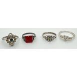 4 silver dress rings, all stone set. To include an Art Deco style set with a square cut red stone