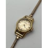 A ladies vintage 551002 automatic wristwatch by Omega. Gold tone case with rolled gold strap. One