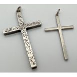 2 silver cross pendants with hanging bales. One plain, the other with engraved decoration to