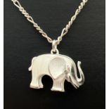 An unmarked white metal pendant modelled as an elephant, on an 18" silver figaro chain with