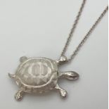 A silver pendant modelled as a tortoise on an 18" silver belcher chain with spring ring clasp.