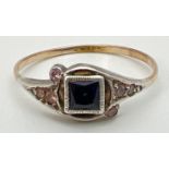 A small Art Deco dress ring with central square cut sapphire flanked by small pink stones in a