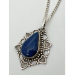 A lapis lazuli set silver pendant on an 18" silver curb chain with lobster claw clasp. Reverse of