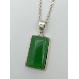 A rectangular shaped apple green jade and 925 silver pendant necklace. Pendant on an 18" silver