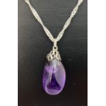 A polished amethyst stone pendant on an 18" silver singapore chain. Chain stamped 925 to spring ring
