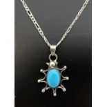 A turquoise set 925 silver pendant of sunburst design, on an 18" silver figaro curb chain with