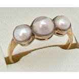 A vintage unmarked 18ct gold 3 stone pearl ring, tests as 18ct gold. Ring size N.