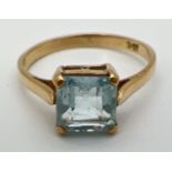 A vintage 9ct gold dress ring set with large square cut blue topaz stone. Stamped 9ct inside band,