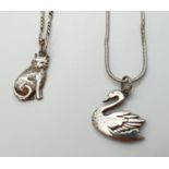 2 white metal animal shaped pendant necklaces on silver chains. An unmarked cat pendant on an 18"