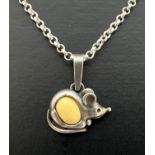 A silver pendant in the form of a mouse set with a small oval cabochon of white amber. On a 16"