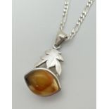 A 925 silver and amber pendant on an 18" 2mm figaro curb chain with lobster claw clasp. Back of