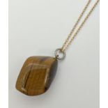 A polished Tigers eye stone pendant on an 18" 14k Rolled gold belcher chain. Stamped '14k rg K&L' to