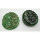 2 Oriental carved roundels, possibly jade, each with small hole for hanging. Carved detail to both