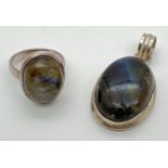 A modern design silver dress ring and matching pendant, both set with an oval of labradorite. Silver