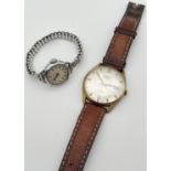 2 vintage wristwatches by Oris. A mens Oris Supra 17 jewel watch with gold tone case, cream face,
