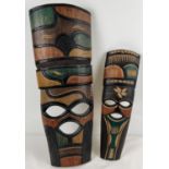 2 African carved wooden masks with carved and coloured detail. Largest approx. 62cm long.