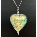 A green and gold foil glass heart shaped pendant on a 16" fine curb chain with an extension chain.