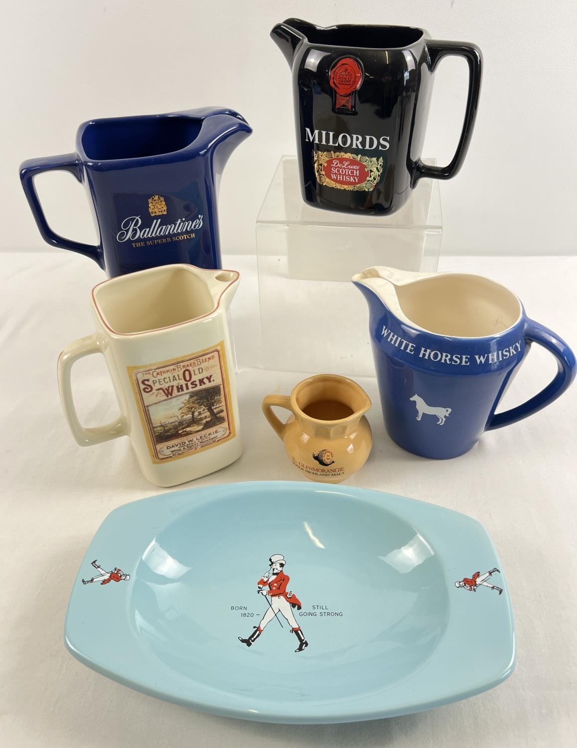 A collection of ceramic whiskey advertising water jugs together with an ashtray. To include Wade