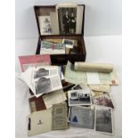 A small vintage brown suitcase of assorted vintage ephemera and photographs. To include WWII army