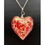 A red and gold foil glass heart shaped pendant on a 16" silver curb chain with spring ring clasp.