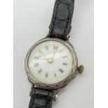 An antique silver cased wristwatch with diamond pattern to case, on a black leather plaited strap.