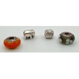 4 charm bracelet beads. 2 glass Pandora beads together with a clear stone set bead and a elephant.