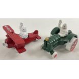 2 small painted cast metal Michelin men figures driving vehicles. With moving wheels and