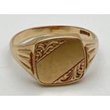 A men's 9ct gold square faced signet ring with engraved detail to corners and central banded empty