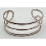 A modern design 3 band cuff bangle. Silver marks to inside. Total weight approx. 19.7g.