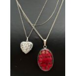 3 silver necklaces. A pressed flower pendant on a fine curb chain, a heart shaped locket with