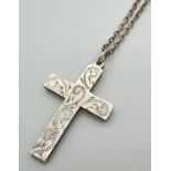 A vintage silver cross pendant with engraved decoration to front, on a 20" belcher chain with spring