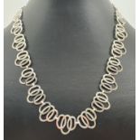 An 18" contemporary design plain and patterned multi oval link Native American silver necklace. With