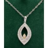 A 9ct white gold marquise shaped pendant with yellow gold accent, set with 23 baguette and 61