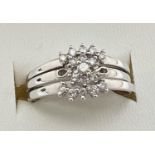 A 9ct white gold and diamond bridal set of 3 rings. Central small diamond cluster ring with 2