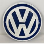 A circular shaped cast iron VW Volkswagen wall plaque painted blue & white. Approx. 23cm diameter.