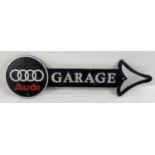 A cast iron Audi Garage wall arrow sign, painted black, silver & red. Approx. 44cm long.