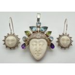 A Silver Sun Goddess pendant and matching drop style earrings by Sajen. Pendant headdress detail set